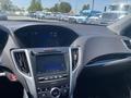 Interior view of a 2017 Acura TLX featuring a touchscreen display and control panel with various buttons and knobs