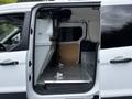 Interior view of a 2016 Ford Transit Connect showing the cargo area with a metal floor and side walls designed for utility and storage