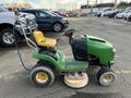 2021 John Deere L Series S lawn mower with a yellow seat and steering wheel featuring a lawn care cutting deck attachment