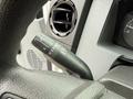 Close-up of the control stalk in a 2015 Ford F-350 SD featuring turn signal and windshield wiper controls