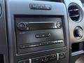 Dashboard controls of a 2014 Ford F-150 including radio and climate control buttons
