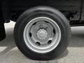 Close-up of a silver wheel and tire from a 2018 Hino 195 showcasing the rim design and tread pattern
