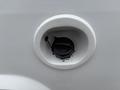Close-up of a fuel filler cap for a 2014 Ford E-350 displaying a black twist-off cap within a round opening