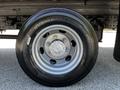 A close-up of a silver wheel and tire from a 2020 Hino 155 showing detailed tread pattern and lug nuts