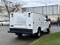 A 2017 Ford F-350 SD with a white service body featuring two compartments and red lights on the back