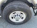 A close-up of a tire mounted on a wheel of a 2012 Chevrolet Express showing the tread pattern and the Chevrolet logo on the wheel center