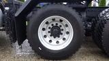 A close-up of the wheel of a 2019 Western Star Trucks 4900 SA showing a shiny silver rim with multiple holes and a large black tire with visible tread