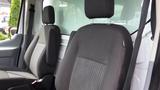 Two front seats of a 2018 Ford Transit with black fabric upholstery and adjustable headrests