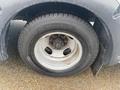 A close-up of a Michelin tire mounted on a wheel of a 2018 Chevrolet Express showing the tread pattern and lug nuts