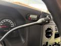 Close-up of the dashboard of a 2010 Ford Econoline showing the speedometer and various dashboard controls including the turn signal lever