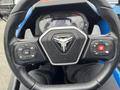 Steering wheel of a 2020 Polaris Slingshot featuring control buttons for audio and cruise settings