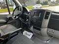 Interior of a 2017 Mercedes-Benz Sprinter featuring a steering wheel and dashboard with various controls and screens