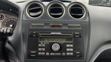 Dashboard of a 2012 Ford Transit featuring a radio control panel with buttons for CD, clock, and auxiliary input