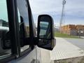 A 2019 Mercedes-Benz Sprinter van with a focus on the side mirror reflecting the surroundings.