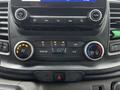 Controls and dials of a 2021 Ford Transit cabin display air conditioning settings and audio controls