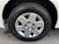 Close-up of a silver alloy wheel on a 2011 Dodge Grand Caravan featuring a Goodyear tire with an all-season tread pattern