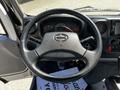 Steering wheel of a 2020 Hino 155 showing the dashboard with speedometer and various controls