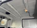 Interior view of a 2015 Chevrolet City Express showing the ceiling with a light and ventilation fan along with white metal panels