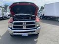 A red 2012 RAM 2500 pickup truck with the hood raised showing the engine compartment
