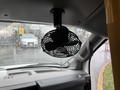 A black ceiling-mounted fan is installed in the front area of a 2020 Chevrolet Express van