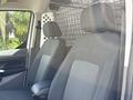 2021 Ford Transit Connect interior featuring two front seats with black fabric upholstery and a mesh divider behind them