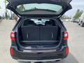 A 2015 Kia Sorento with its rear hatch open, showcasing a spacious cargo area with the rear seats folded down