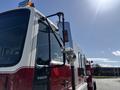 A red and white 1994 Volvo FE 42 fire truck with a prominent side mirror and emergency lights mounted on the roof