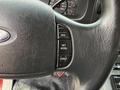 Close-up of the steering wheel controls of a 2007 Ford F-550 featuring buttons for resume set accelerate and coast