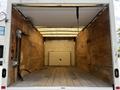 Interior view of a 2018 Ford Econoline cargo van with wooden floors and walls showing no cargo or equipment