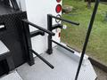 Two black metal storage racks mounted on the back of a truck designed for holding equipment or tools