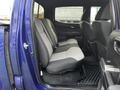 Interior view of a 2022 Toyota Tacoma showing the rear seats with gray upholstery and a black trim