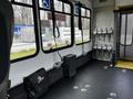Interior view of a 2016 Ford Econoline with seating, handrails, and safety equipment displayed on the wall
