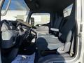 Interior view of a 2014 Mitsubishi Fuso FE with three seats in the cabin and a central dashboard area