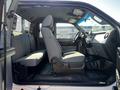 Interior view of a 2011 Ford F-350 SD showing the front seats and dashboard with gray fabric upholstery and a black floor mat