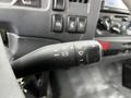 Close-up of the control stalk in a 2022 Isuzu NPR featuring buttons for headlights wipers and turn signals