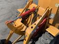 Close-up of a yellow Traner TR 45 construction machine's hydraulic arm and attachment system