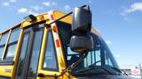 A yellow 2014 Freightliner Thomas diesel school bus with large side mirrors and a prominent front window