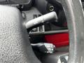 Close-up of the steering wheel controls of a 2018 Hino 195 showing turn signal and cruise control levers