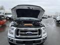 2016 Ford F-150 with the hood open revealing the engine compartment and various components under the hood