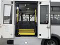 A 2018 Chevrolet Express with an open rear door displaying a foldable wheelchair ramp in the entryway