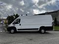 A 2019 RAM Promaster van in white parked with a clean side profile showing windows and wheels