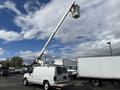 A 2008 Ford Econoline van with an extended aerial lift mechanism attached to the roof designed for accessing high locations