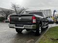 A gray 2020 RAM 3500 truck with a distinctive rear design and chrome accents parked in a lot, showcasing its sturdy build and 4x4 capability