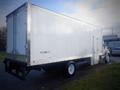 A 2013 Hino 308 box truck with a white cargo area and black chassis positioned at an angle