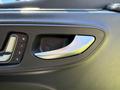 Close-up of the door handle and controls inside a 2023 Mercedes-Benz Sprinter featuring a sleek design and metallic accents