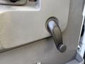 Close-up of the door handle and lock mechanism of a 2020 Chevrolet Express in a light gray interior setting