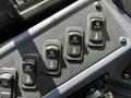 A control panel featuring several toggle switches with labels for heating, including options for front and rear heater settings and an air pump switch