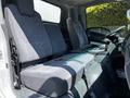 Interior view of a 2007 GMC W3500 showing two gray upholstered front seats and a center console