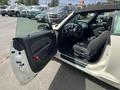 A 2005 Chrysler PT Cruiser with the driver's side door open showcasing the interior featuring black seats and dashboard controls