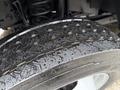 Close-up of a wet tire tread on a 2020 Ford F-550 showcasing the detailed grooves and patterns of the rubber surface